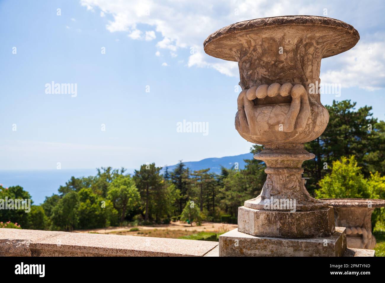 Vase décoratif en pierre ancienne dans un jardin par temps ensoleillé. Massandra, Crimée Banque D'Images