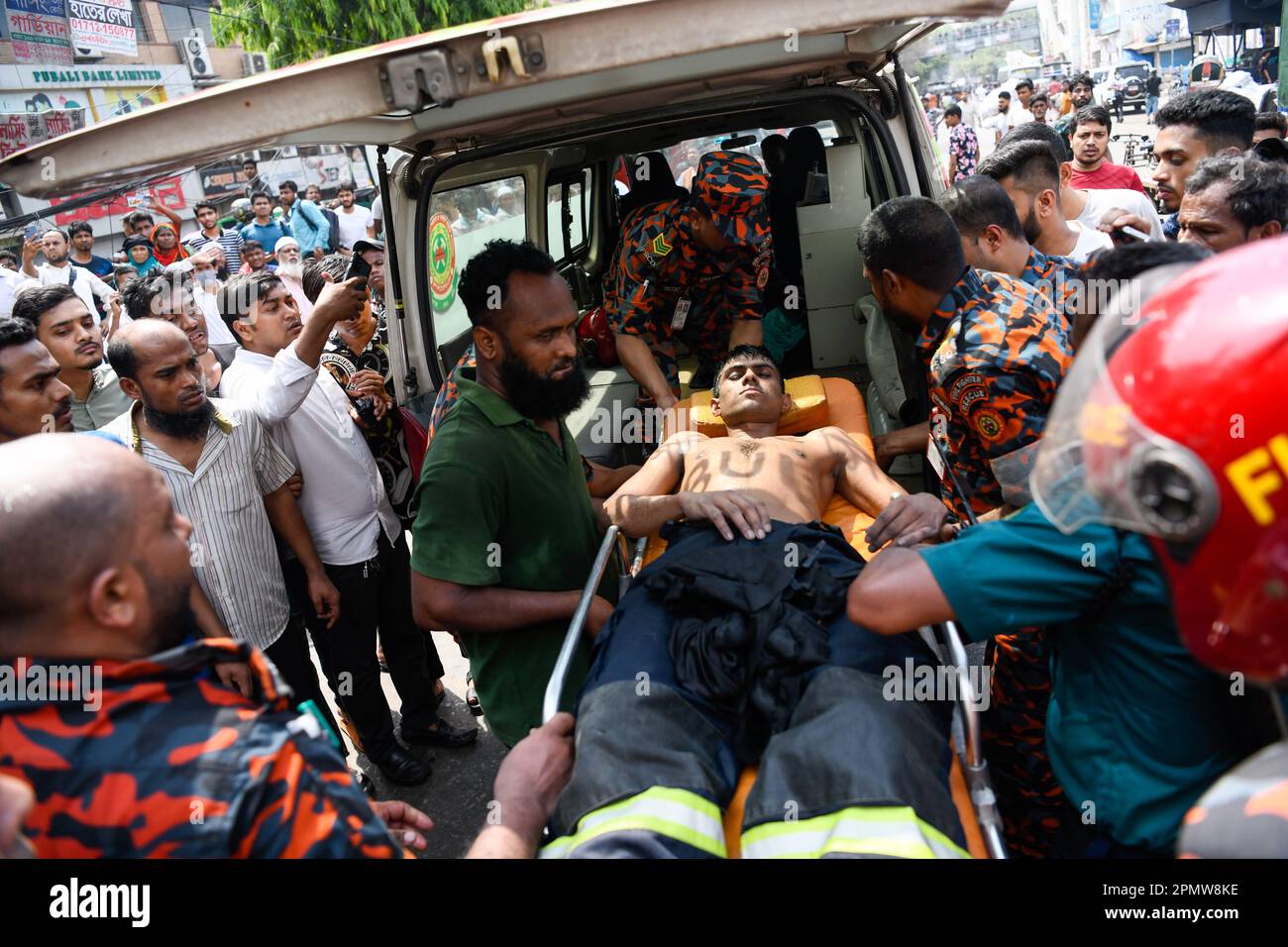 Un pompier est tombé malade et a été envoyé à l'hôpital en ambulance après un incendie horrible qui a fait des magasins sur le marché de l'habillement de Dhaka. Un grand incendie a ravagé des milliers de magasins sur un marché populaire de l'habillement dans la capitale bangladaise, Dhaka, où les propriétaires de magasins ont été dévastés par les pertes des semaines précédant l'Eid, le festival musulman marquant la fin du Ramadan. Des centaines de pompiers et de militaires ont lutté contre l'inferno alors qu'il a déchiré le marché de l'habillement, en le transformant en une pile de cendres. Plusieurs personnes ont été blessées, mais aucun décès n'a été signalé jusqu'à présent. Les autorités tentaient toujours de comprendre Banque D'Images
