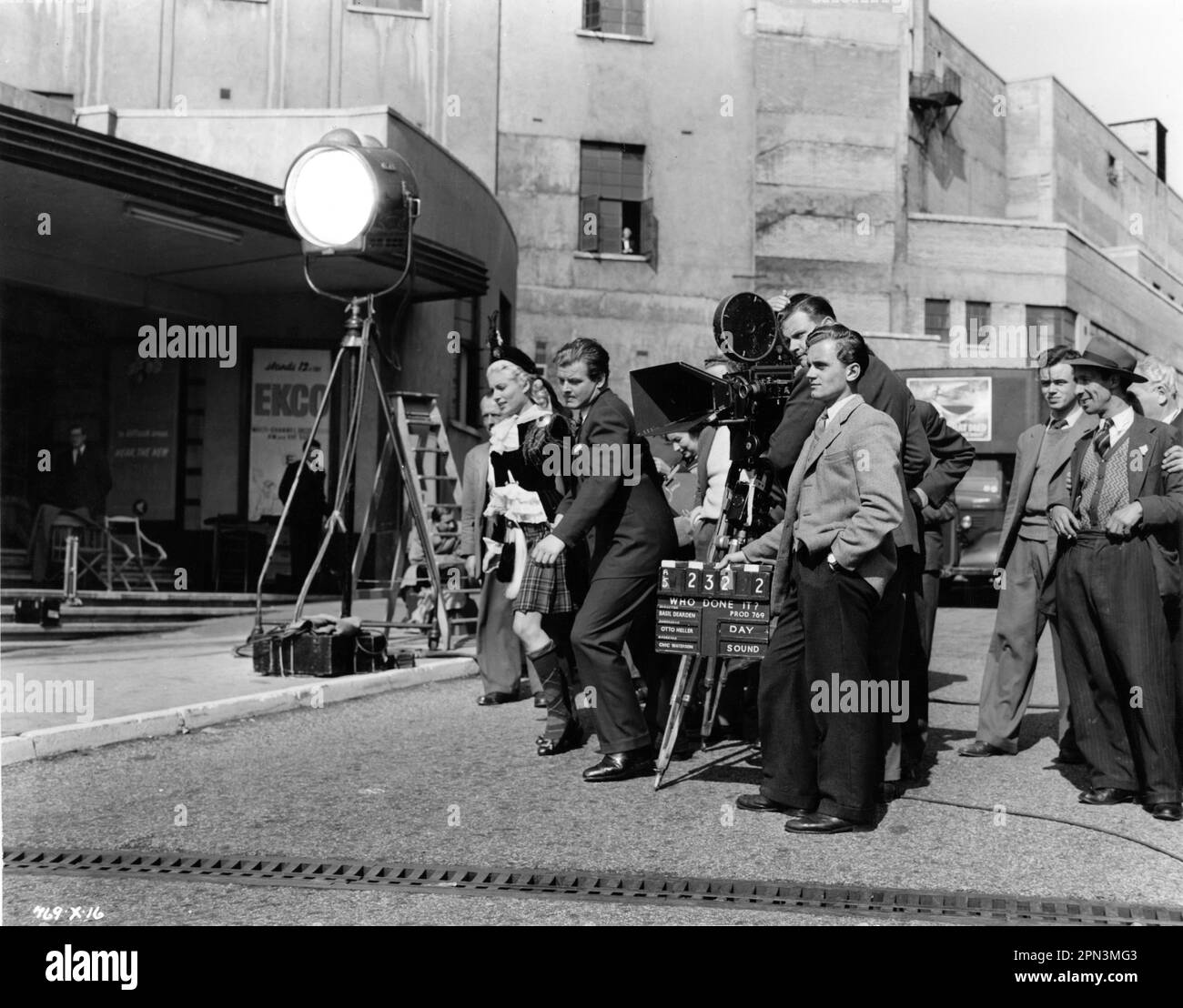 BELINDA LEE et BENNY HILL sur le terrain Candid avec film / caméra équipe pendant le tournage de QUI A FAIT ? 1956 réalisateur BASIL DEARDEN Story / scénario T.E.B. Clarke costume design Anthony Mendleson coproducteurs Basil Dearden et Michael Relph producteur exécutif Michael Balcon Ealing Studios / Michael Balcon Productions / The Rank Organisation Banque D'Images