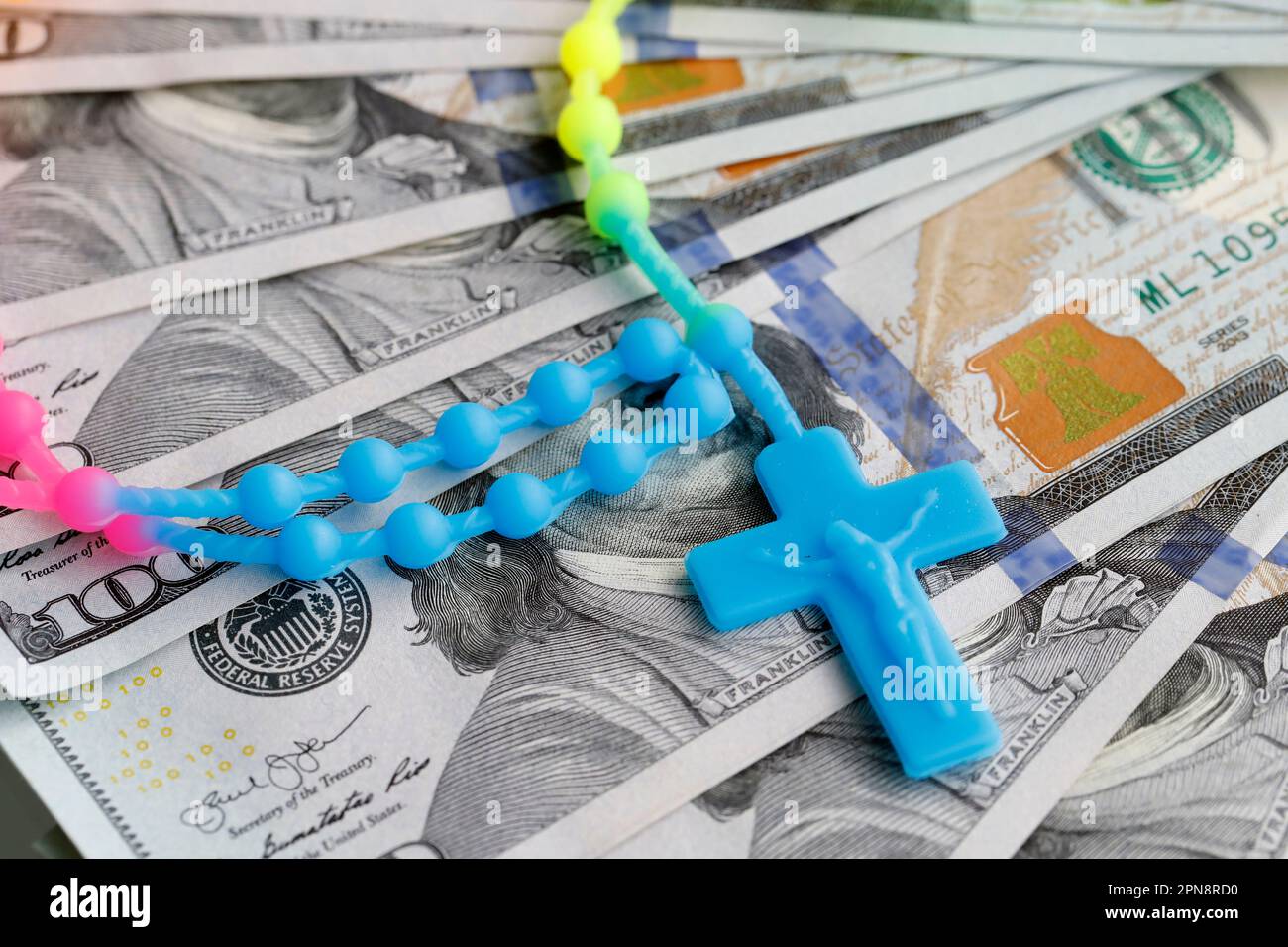 Argent et religion. Billets de dollars américains avec rosaire. Concept de finance, d'économie et de foi catholique. Banque D'Images