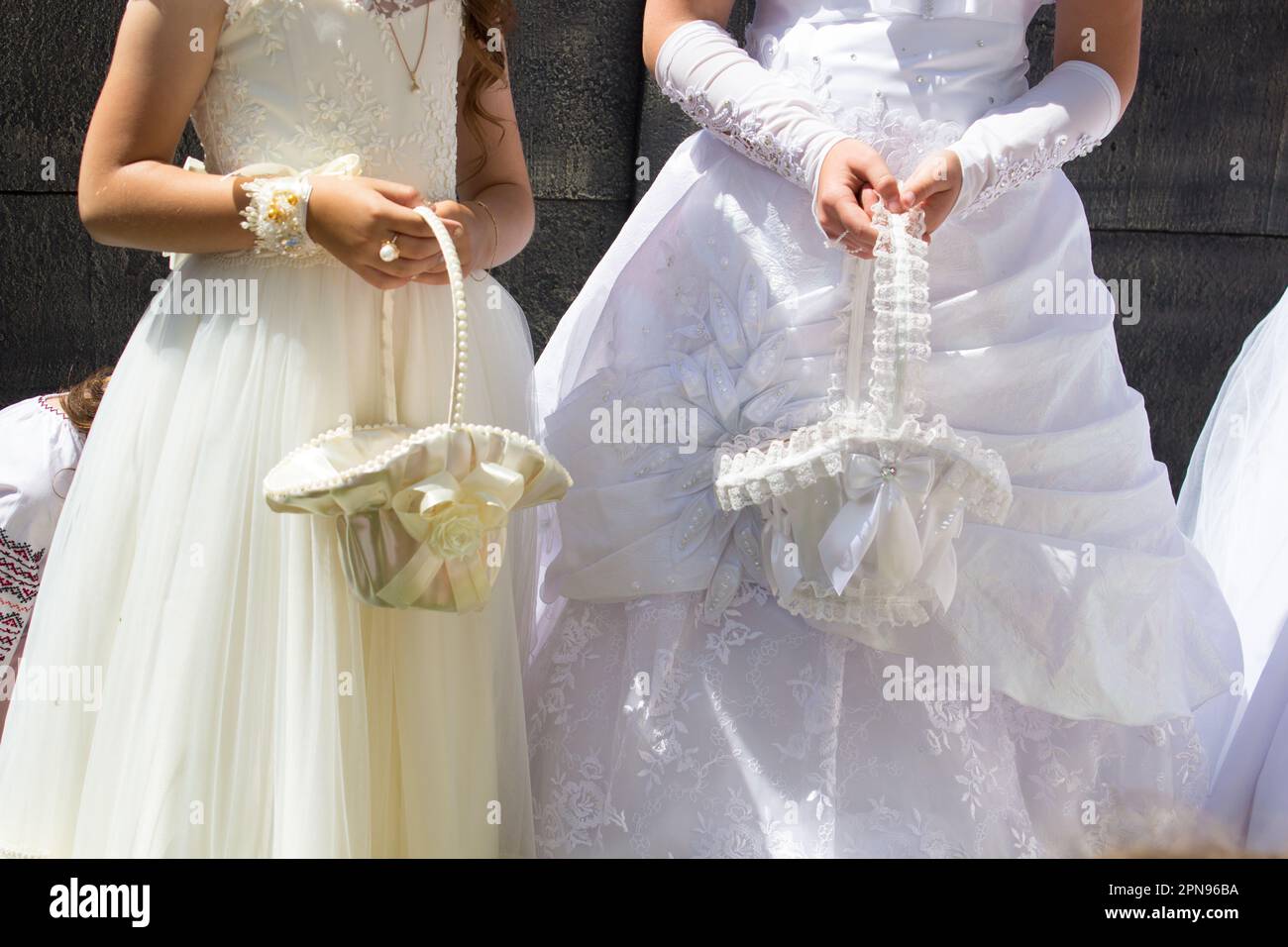 vacances première communion, deux filles vêtues de blanc, portant des paniers Banque D'Images