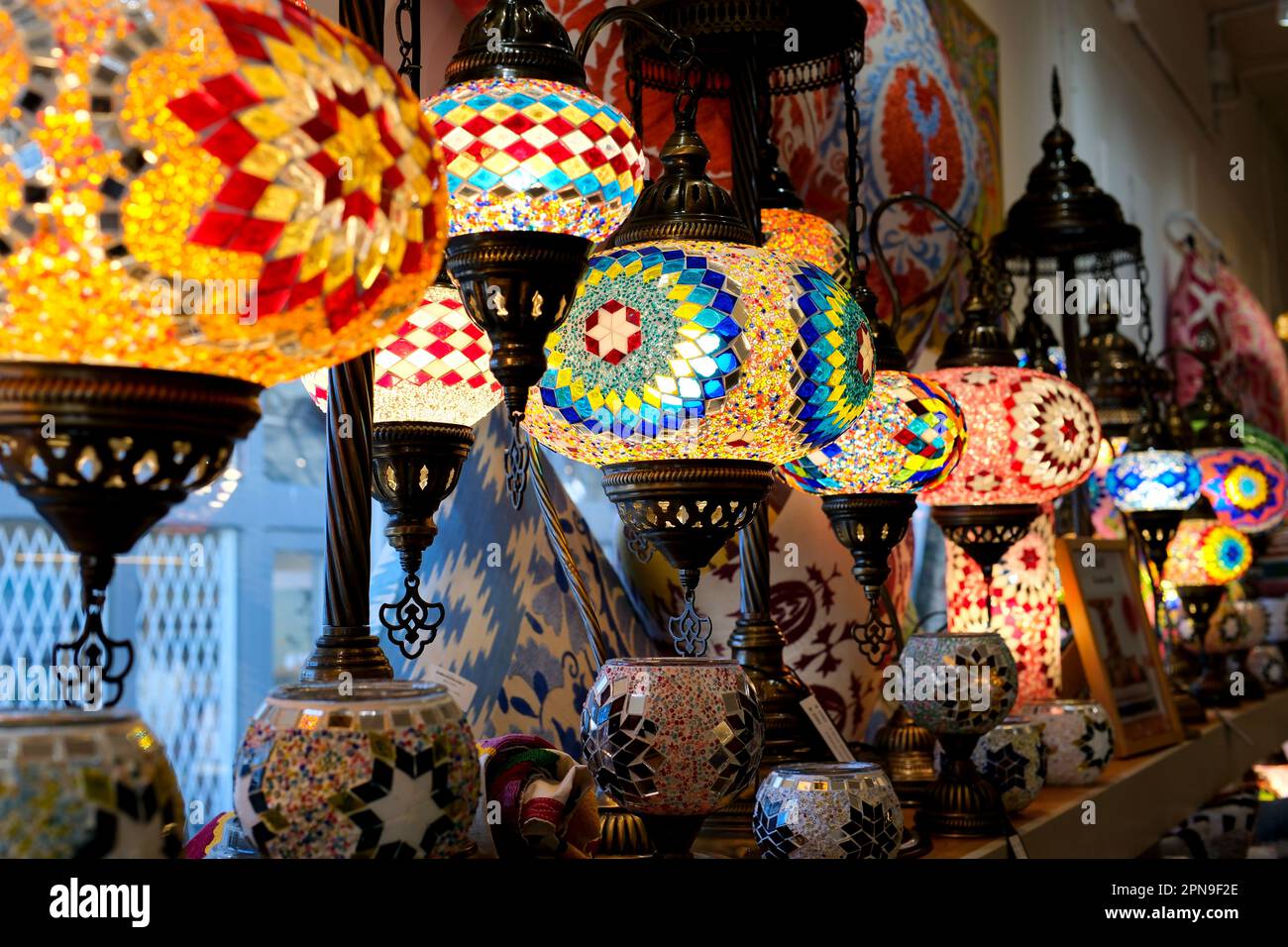 Les lampes turques du magasin sur le comptoir sont des lampes multicolores allumées et illuminent le cadre d'une mosaïque scintillante Banque D'Images