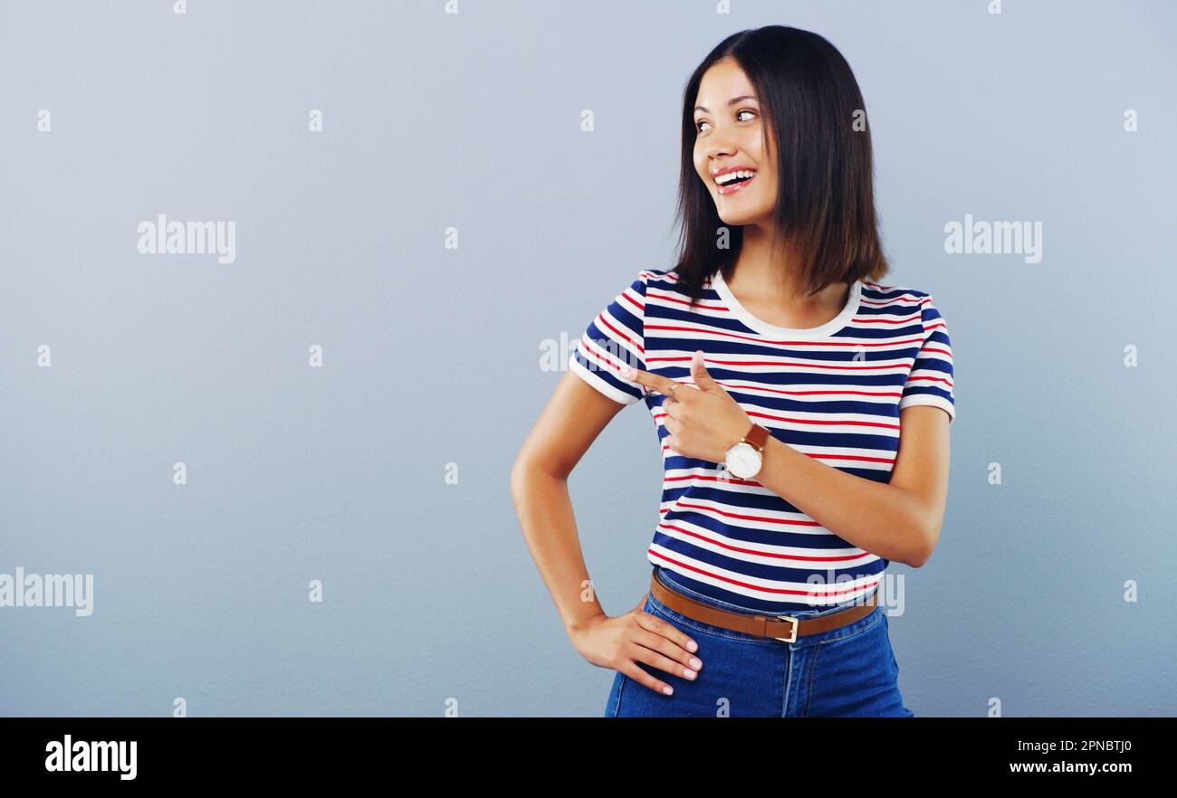 La prochaine grande chose. Photo en studio d'une jeune femme attirante montrant l'espace de copie sur fond gris. Banque D'Images