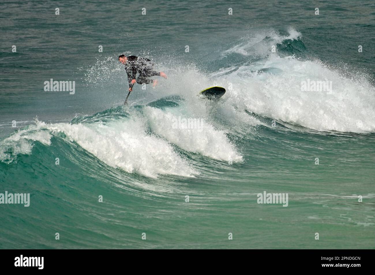 Cornwall, Royaume-Uni. 18th avril 2023. Au cours d'une après-midi chaude et venteuse à Sennen Cove, la maison de surf d'un surfeur Lone prend un Tumble. Crédit photo : Robert Timoney/Alay Live News Banque D'Images