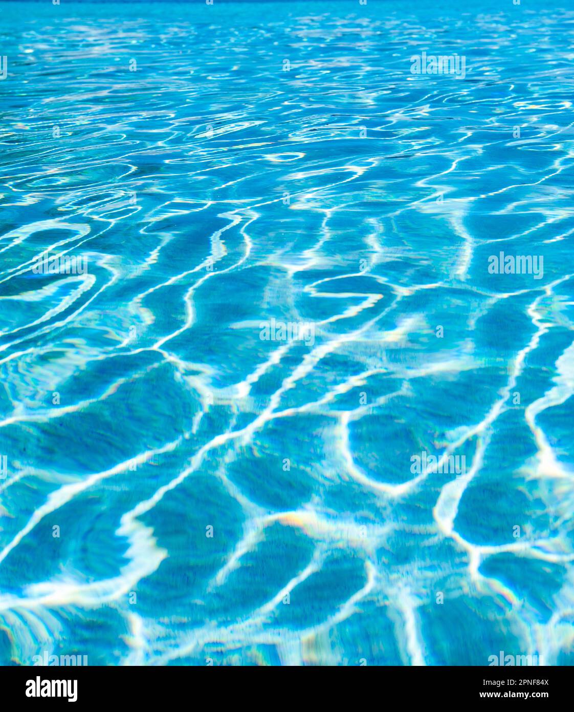 Surface d'eau calme reflétant la lumière du soleil Banque D'Images