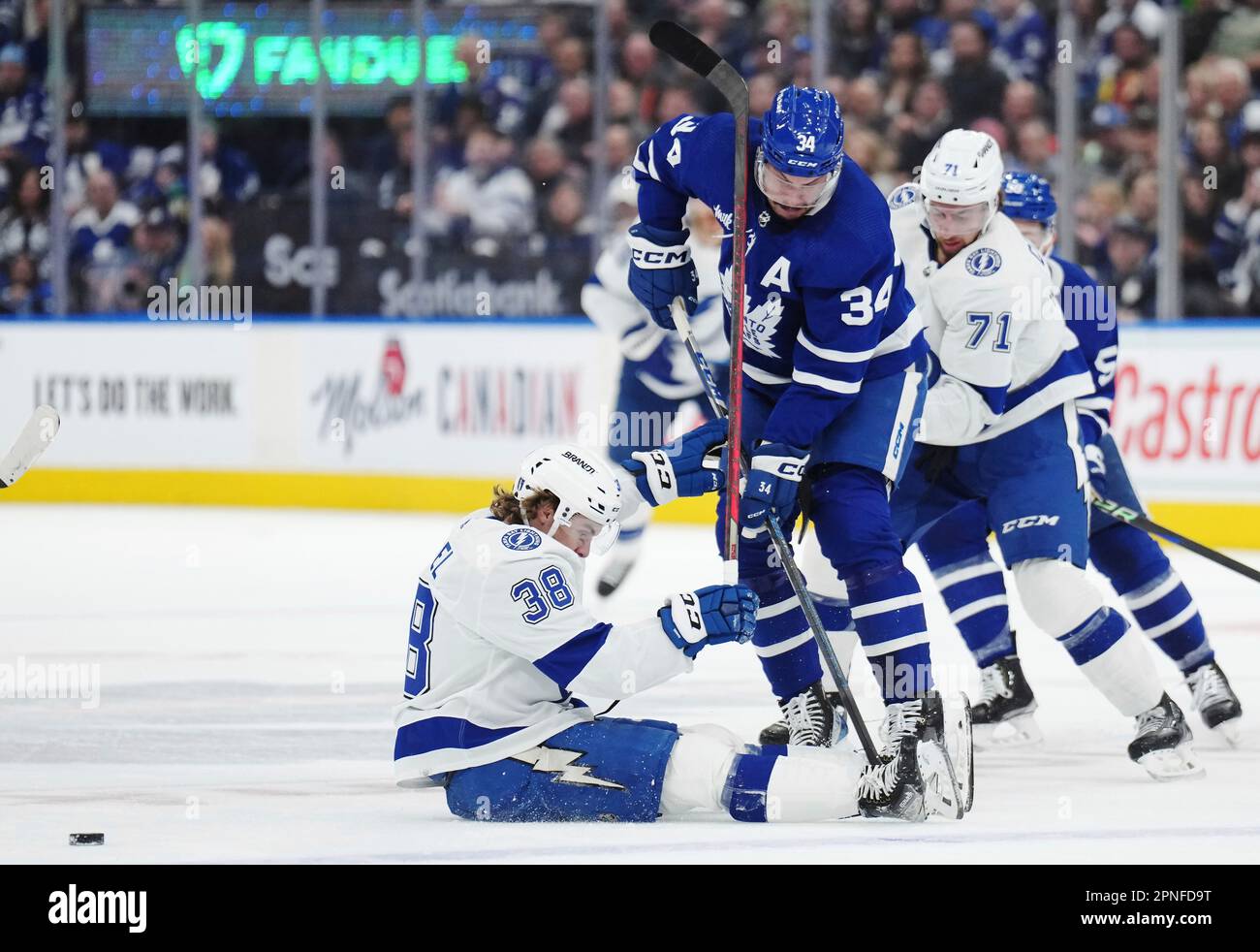 Tampa Bay Lightning left wing Brandon Hagel (38) falls to the ice while