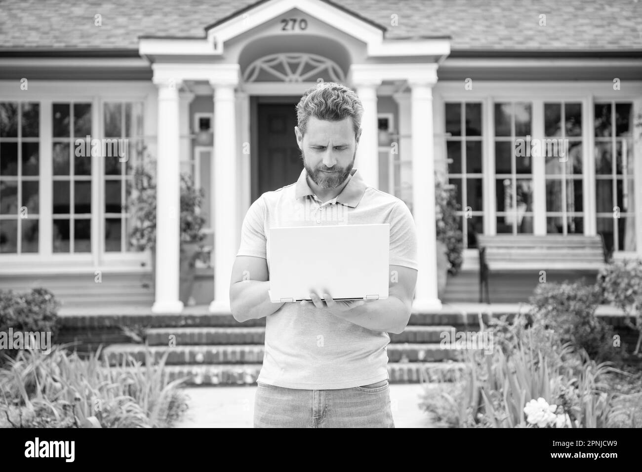 homme barbu occupé agent immobilier vendant ou louant la maison en ligne sur ordinateur, courtier Banque D'Images