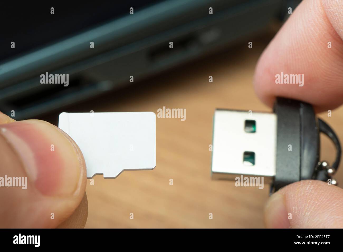 connexion de la carte micro sd de l'adaptateur de lecteur flash usb à l'ordinateur portable. carte micro sd dans la main d'un homme Banque D'Images