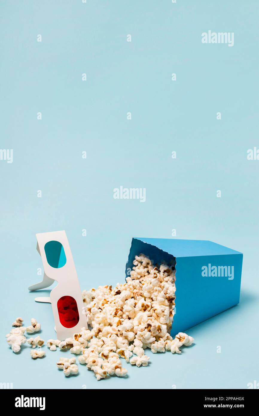 3d verres avec fond bleu de popcorns renversé Banque D'Images