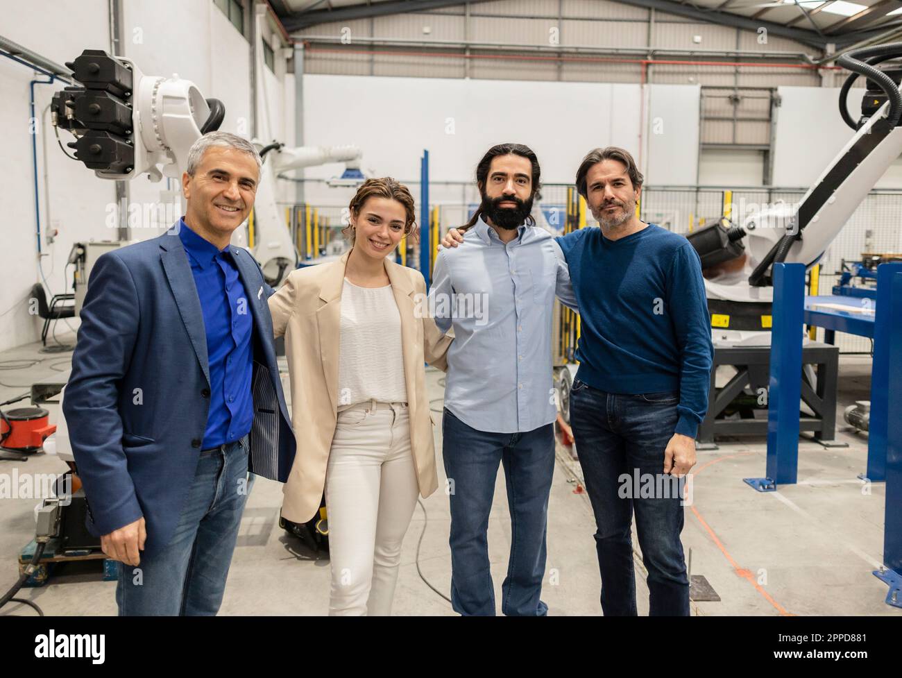 Des ingénieurs souriants se tenant ensemble en usine Banque D'Images