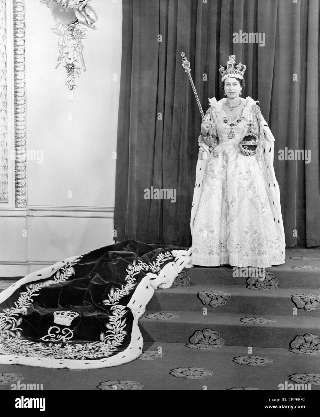 Photo du dossier datée du 02/06/53 de la reine Elizabeth II dans la salle du trône à Buckingham Palace, après son couronnement à Westminster Abbey, Londres. La Reine était adamant sa robe de couronnement historique de 1953 devrait représenter des pays du monde entier sur lequel elle régnait. La robe en satin richement brodée, créée par le couturier britannique Sir Norman Hartnell, est considérée comme l'un des exemples les plus importants du design du 20th siècle. Date de publication : lundi 24 avril 2023. Banque D'Images