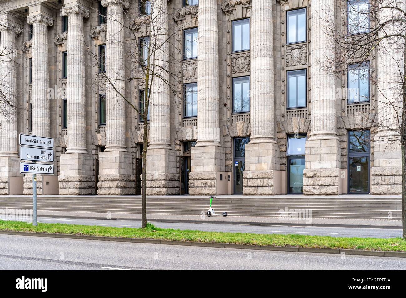 Cologne, Allemagne - 23 mars 2023: Bâtiment administratif historique avec un scooter électrique moderne en face de l'entrée Banque D'Images