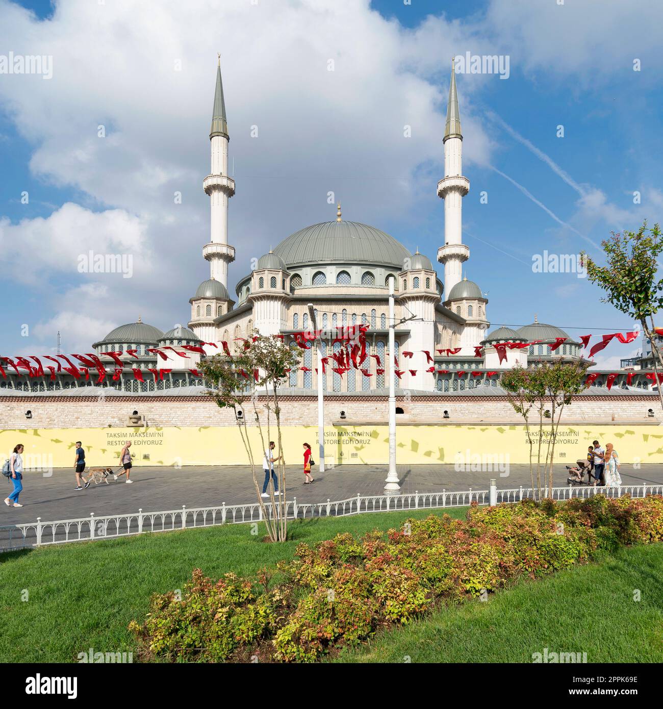 Touristes marchant devant la mosquée Taksim, sur la place Taksim, Istanbul, Turquie Banque D'Images