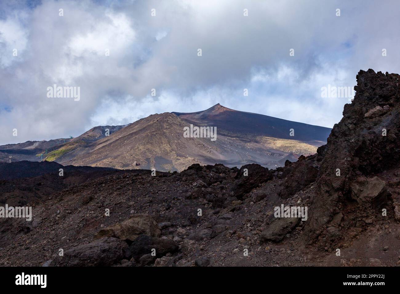 pic de l'etna sur la sicile dormant un jour clair avec un mur de lave solide au premier plan Banque D'Images