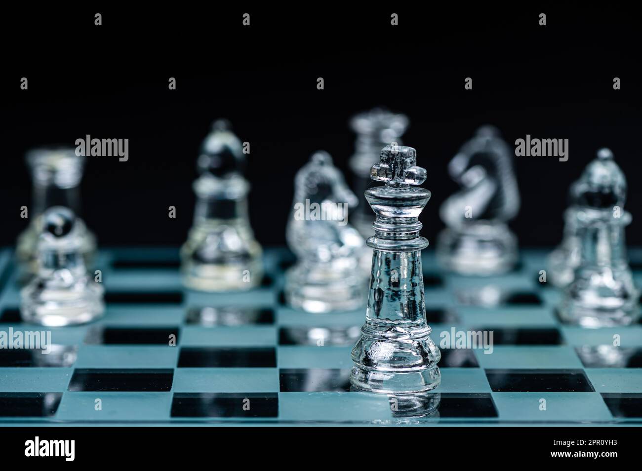 Jeu de plateau d'échecs en verre dans fond noir, focus sélectif sur King, leadership, concept gagnant Banque D'Images