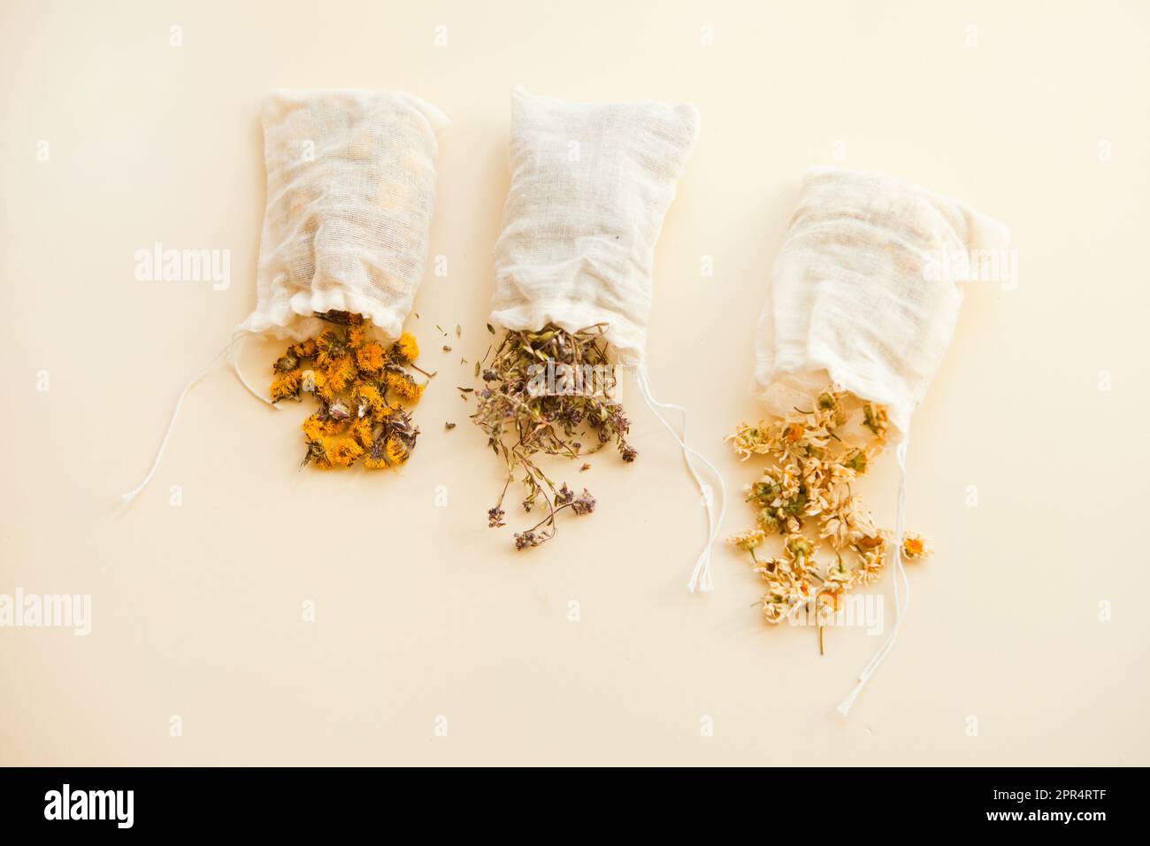 herbes séchées dans des sacs blancs de coton par le dessus. Sachets remplis d'herbes médicinales et de petits pains Banque D'Images