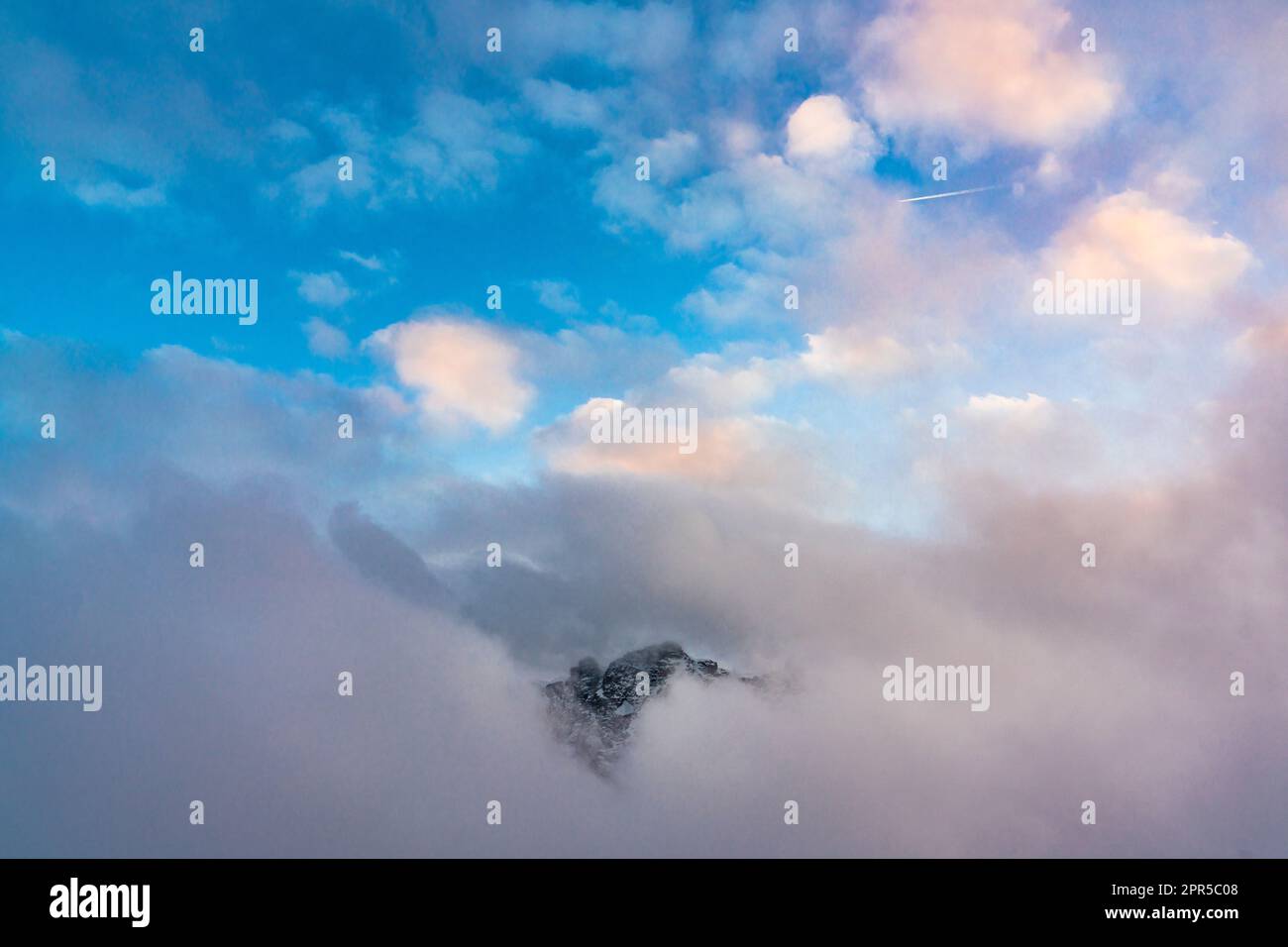 Pic de montagne émergeant du brouillard au coucher du soleil, Gornergrat, Zermatt, canton du Valais, Suisse Banque D'Images