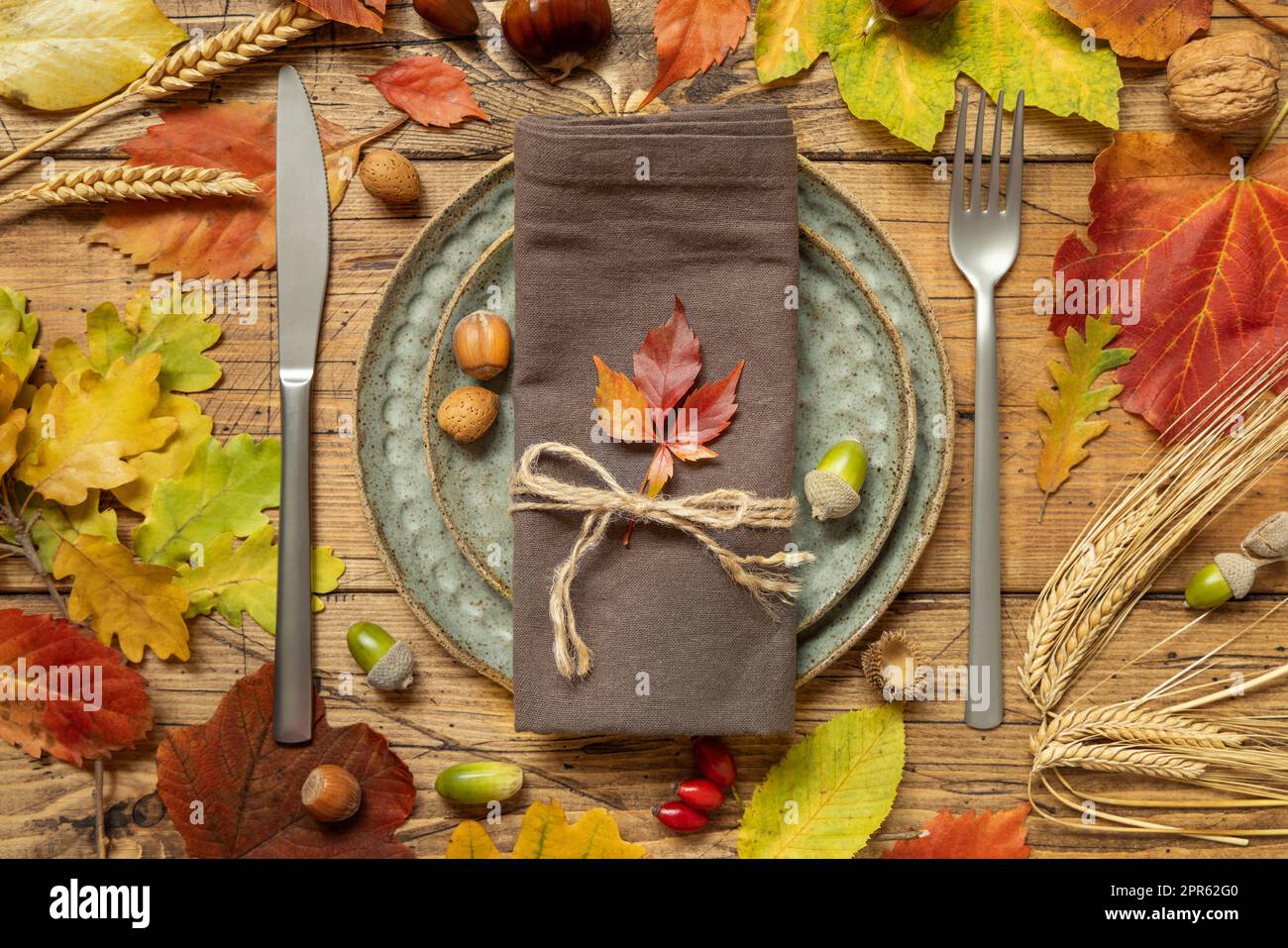 Table rustique d'automne entre les feuilles et les baies, vue sur le dessus de table en bois vintage Banque D'Images