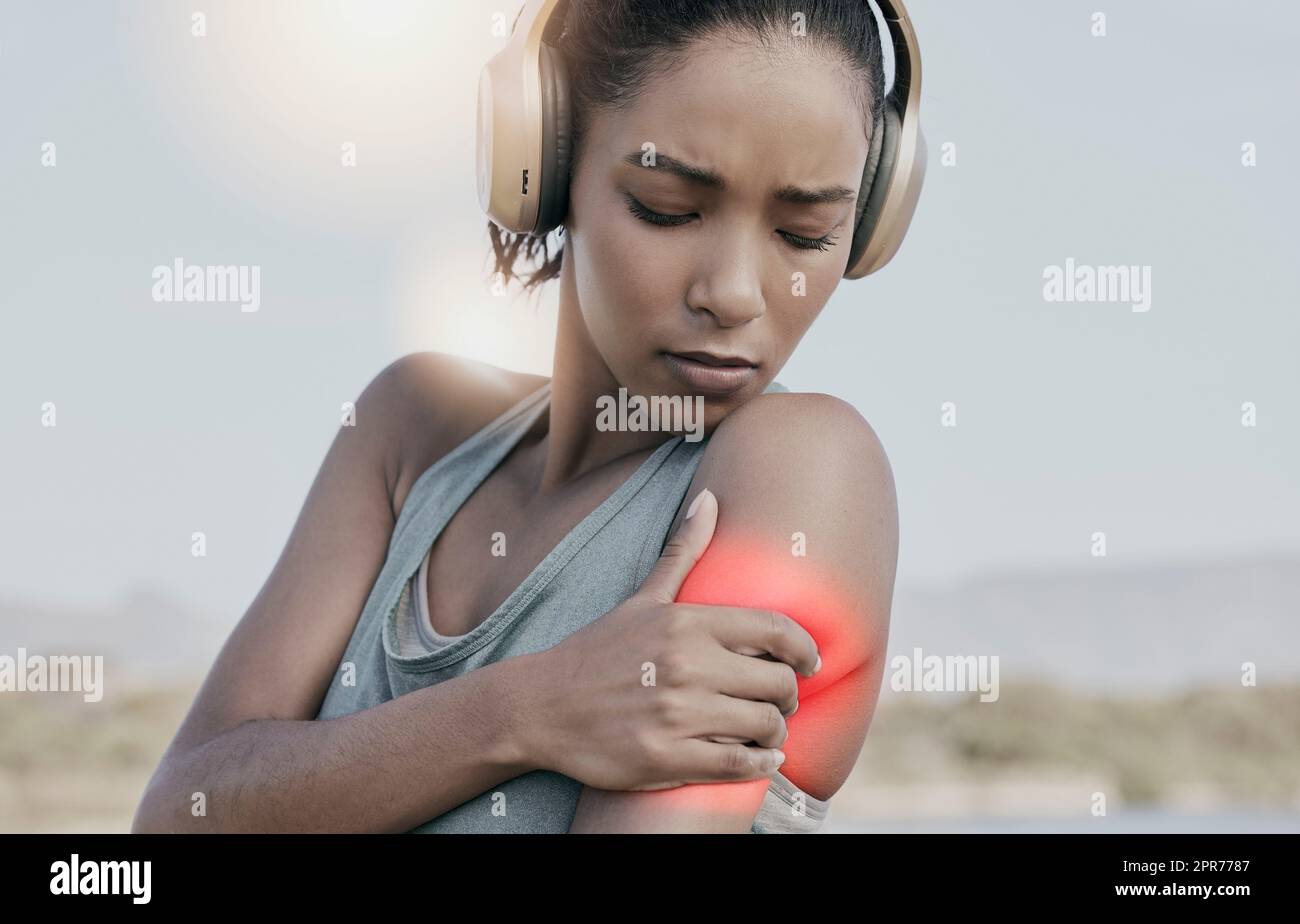 Athlète féminine avec une douleur d'épaule après un entraînement intense. Jeune femme sportive blessée ou blessée au bras mise en évidence en rouge. Une femme athlétique souffrant d'inflammation ou de muscle raide Banque D'Images