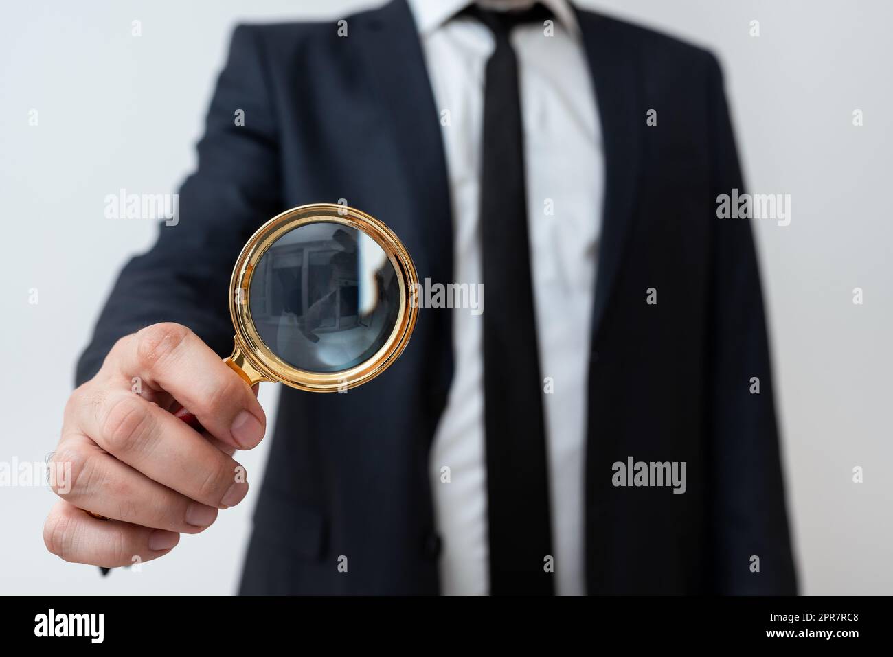 Homme d'affaires tenant la loupe d'une main. Homme ayant une loupe pour signaler des informations importantes. Homme Zooming message crutial. Cadre présentant une nouvelle idée. Banque D'Images