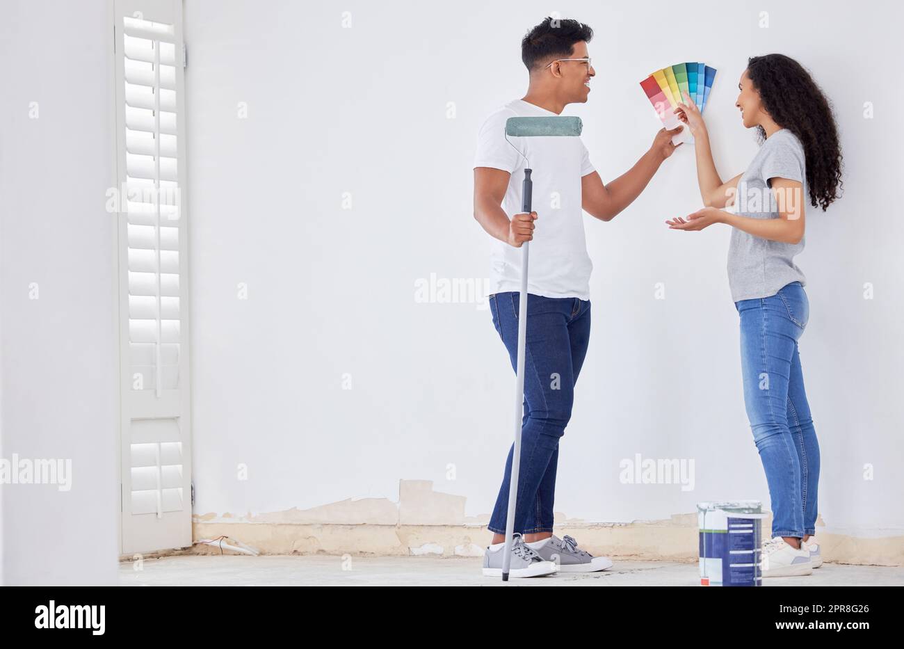 Décider de la couleur est la partie difficile. Photo d'un jeune couple regardant les nuances de couleurs tout en peignant une pièce. Banque D'Images