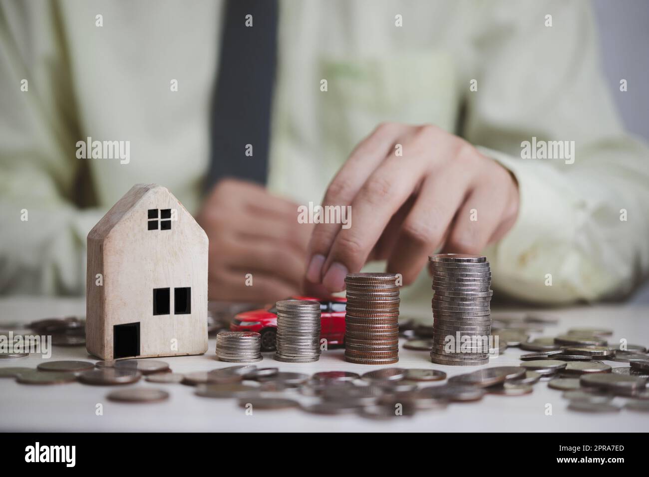 Plan finance des investissements et des économies pour acheter maison immobilier et voitures.argent pièce et voiture et maison sur table comptabilité d'affaires et impôts et concept d'assurance. Banque D'Images