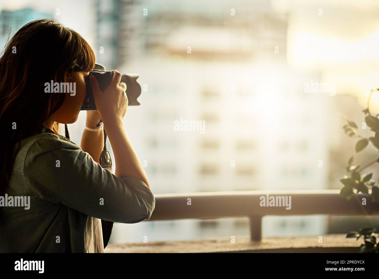 Appréciez les petites choses autour de vous. Une femme prenant des photos avec son appareil photo à l'extérieur. Banque D'Images