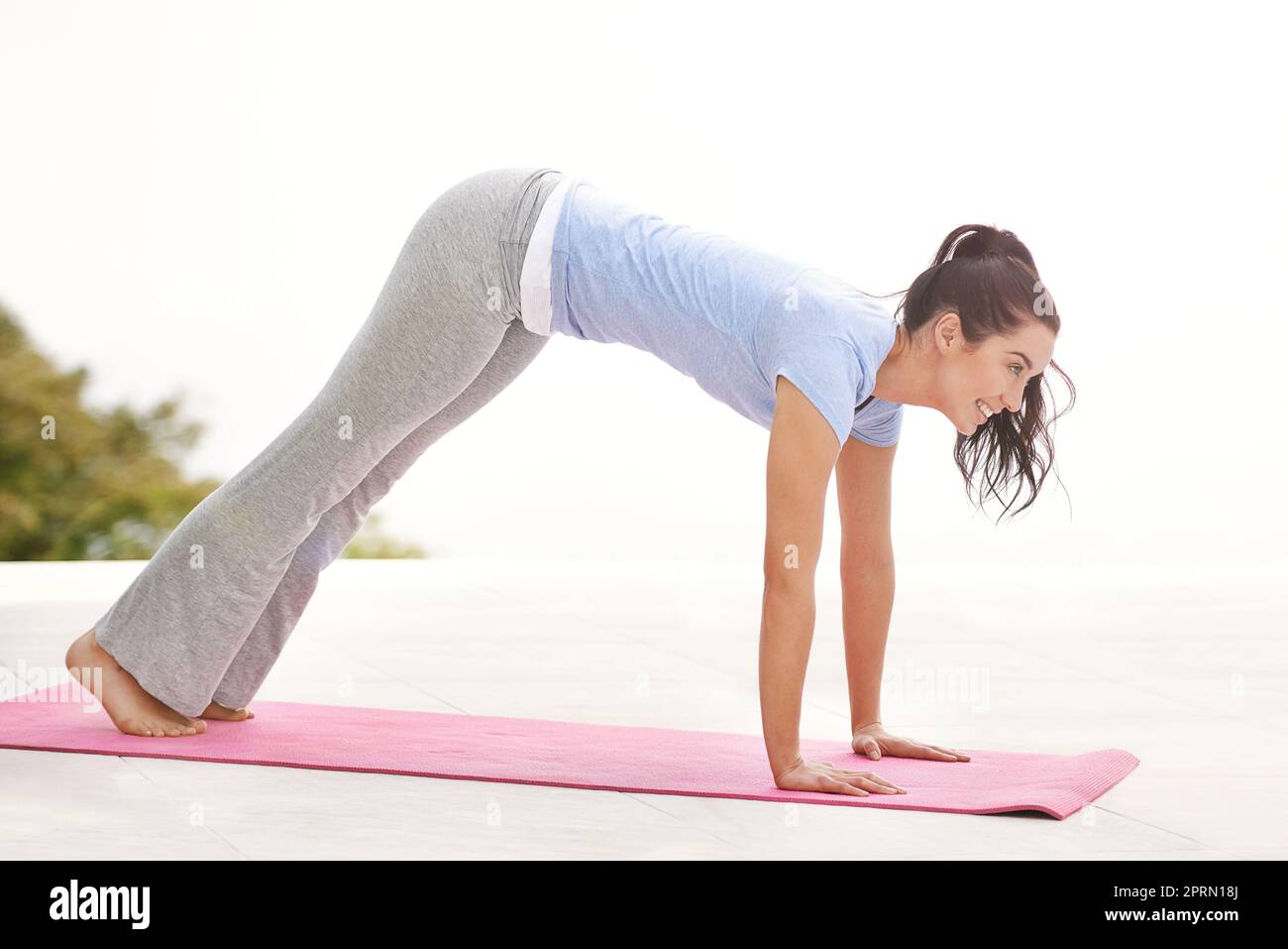 Venez vous détendre en prenant un peu de yoga. Prise de vue en longueur d'une jeune femme faisant du yoga à l'extérieur. Banque D'Images