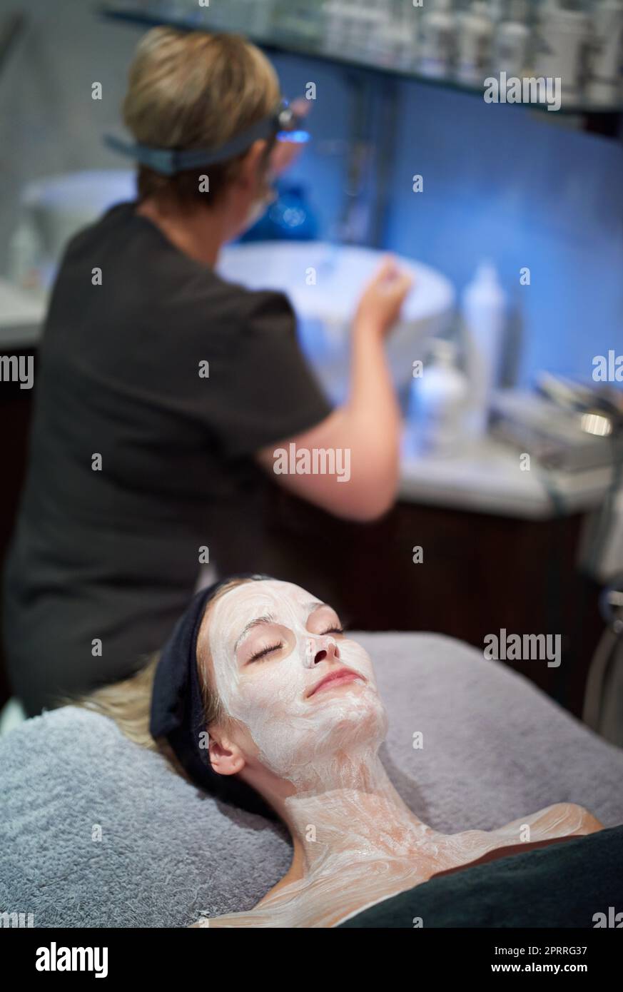 Une femme qui se fait soigner le visage dans une clinique. Banque D'Images