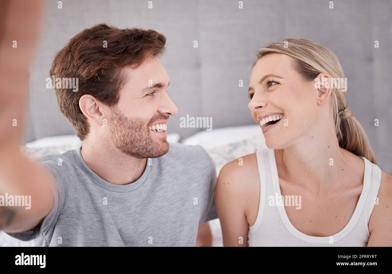 Couple selfie, heureux amour et se détendre dans la chambre à la maison, sourire pour le mariage et streaming en direct sur les médias sociaux ensemble dans la maison. Homme et femme influenceur avec photo pour Internet en ligne pendant les vacances Banque D'Images