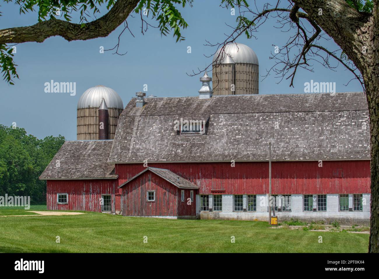 Une belle grange bien entretenue et des silos dans la campagne du Midwest. Banque D'Images