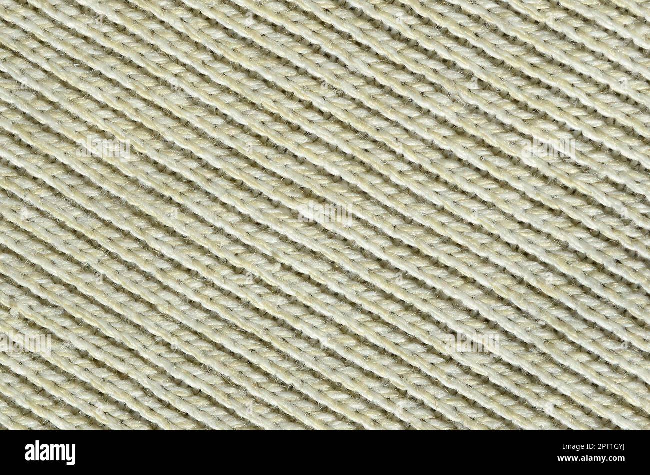 Texture en tissu d'un pull jaune doux. Macro image de la structure des liaisons en fils Banque D'Images