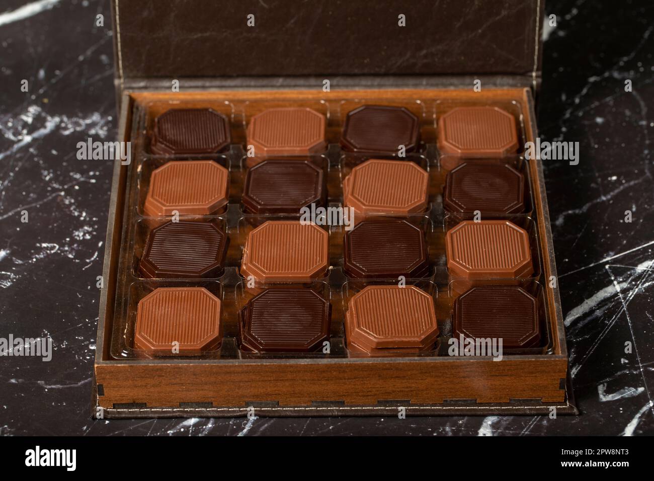 Chocolat madlen emballé. Chocolat carré laiteux et amer. Cadeau ou célébration. Gros plan Banque D'Images