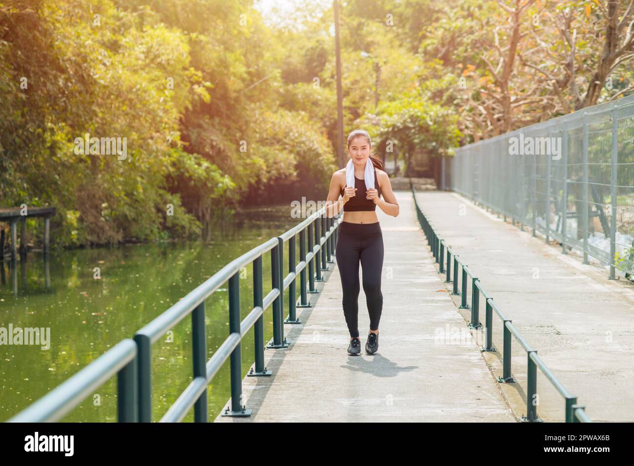 Femme asiatique en forme saine courant jogging urbain en plein air seul le matin heureux sourire Banque D'Images