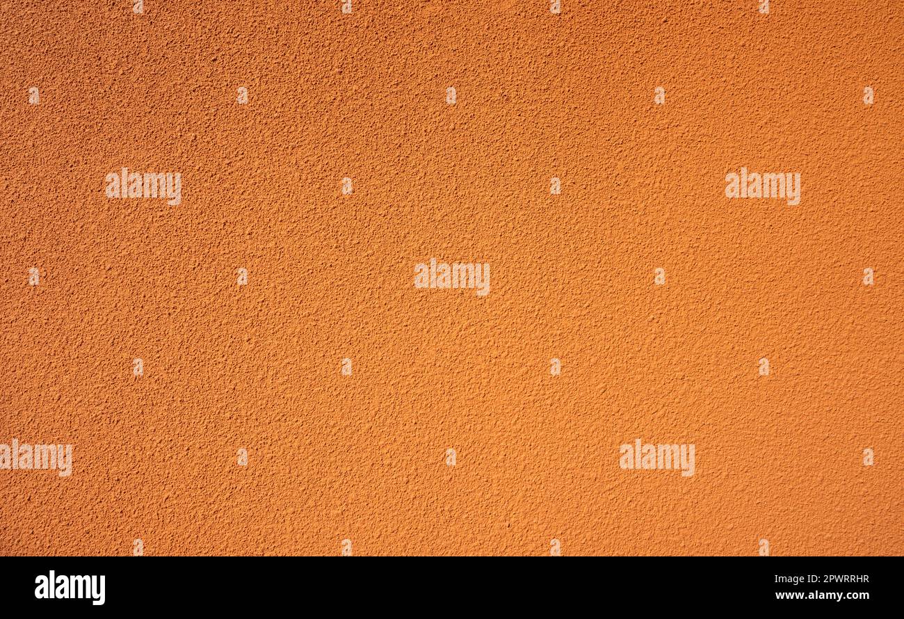 Fond de texture de mur en béton rugueux orange. Arrière-plan abstrait de mur en béton orange vide. Fond de texture de mur de ciment orange plein cadre. Vide Banque D'Images