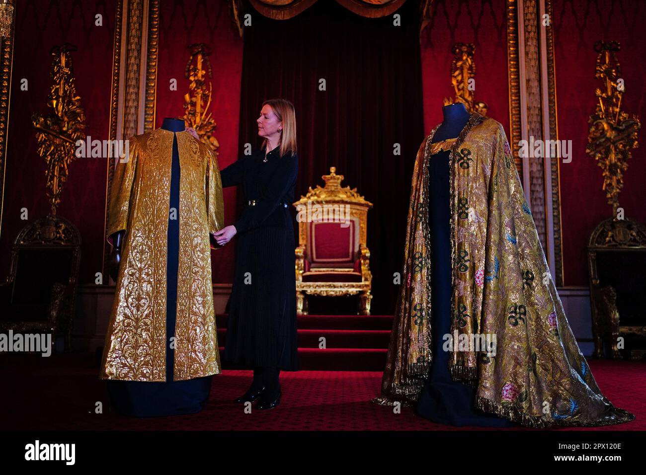 Les vêtements de Coronation, comprenant la Supertunica (à gauche) et le manteau impérial (à droite), exposés dans la salle du Trône à Buckingham Palace, Londres. Les vêtements seront portés par le roi Charles III lors de son couronnement à l'abbaye de Westminster sur 6 mai. Date de la photo: Mercredi 26 avril 2023. Banque D'Images