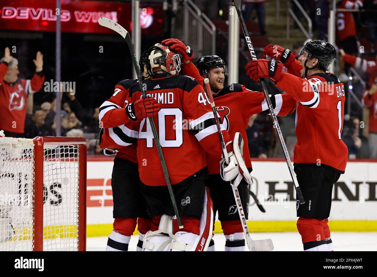 New Jersey Devils goaltender Akira Schmid celebrates with teammates ...