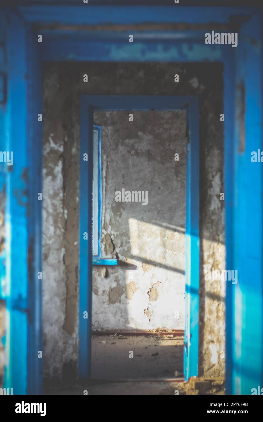 Couloir étroit à l'intérieur d'un bâtiment abandonné éclairé par la lumière du soleil concept photo Banque D'Images