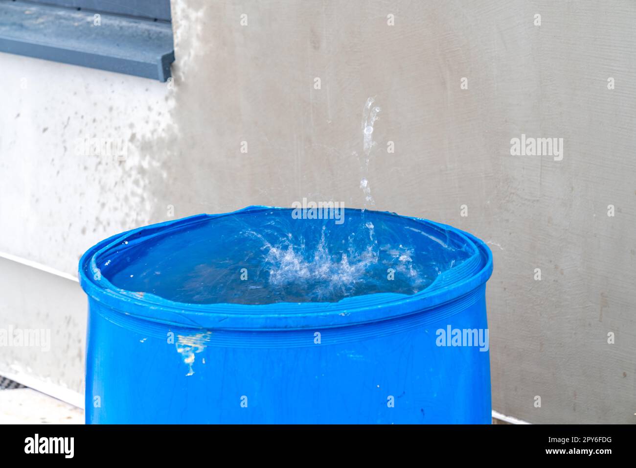 eau de pluie dans un baril en face de la maison Banque D'Images