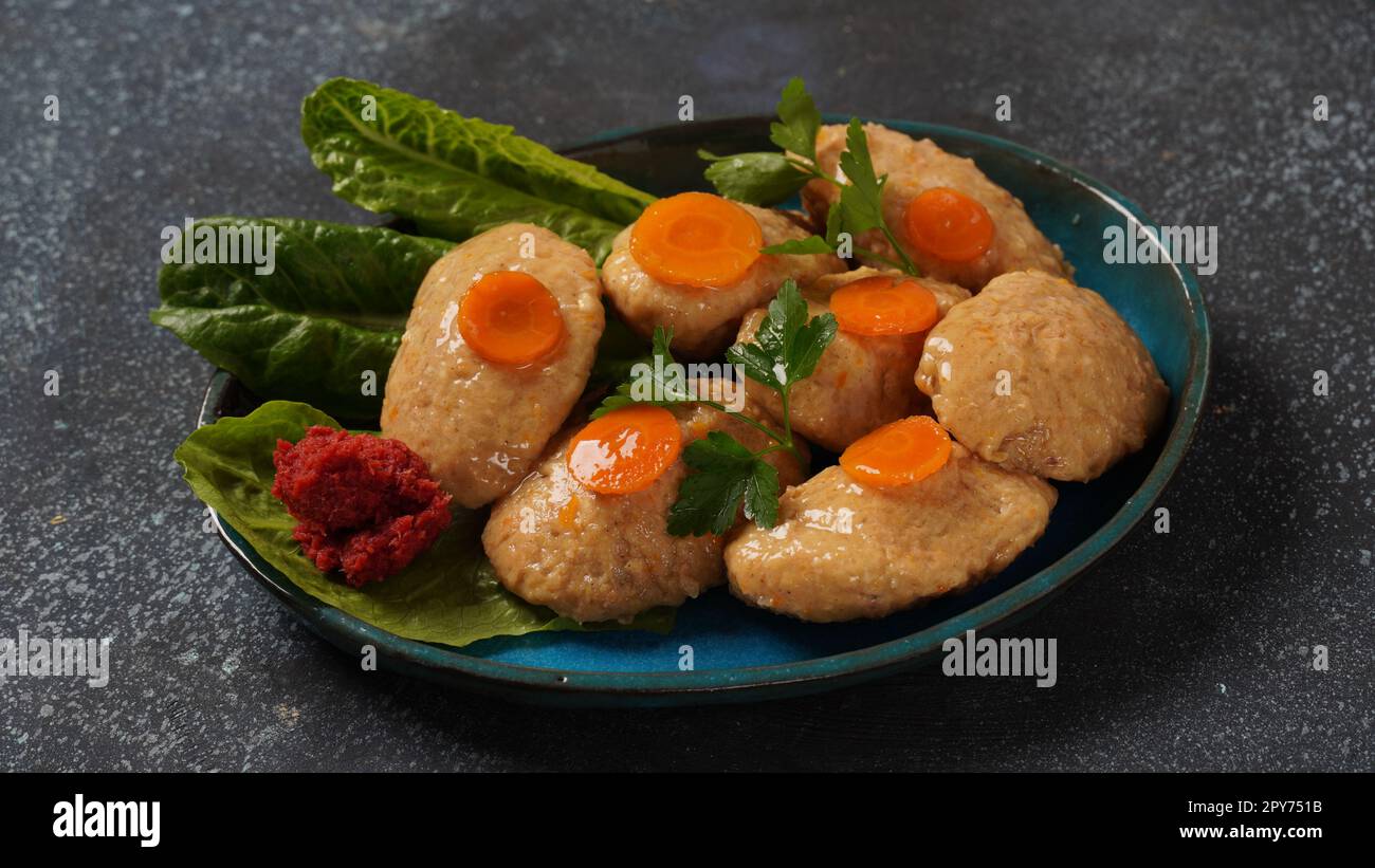 Poisson Gefilte avec carottes, laitue, radis de cheval. La Pâque traditionnelle de la nourriture juive - concept de célébration Banque D'Images