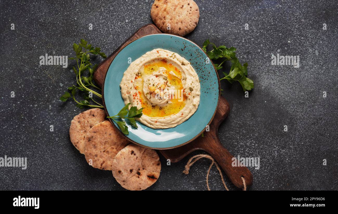 Houmous à l'huile d'olive, paprika, citron et pain pita. Houmous classiques sur l'assiette Banque D'Images