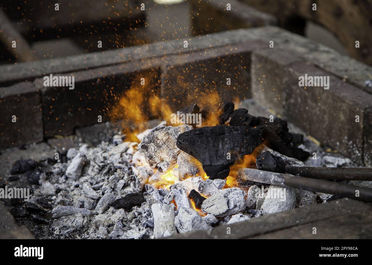 Brûler du charbon dans une forge Banque D'Images