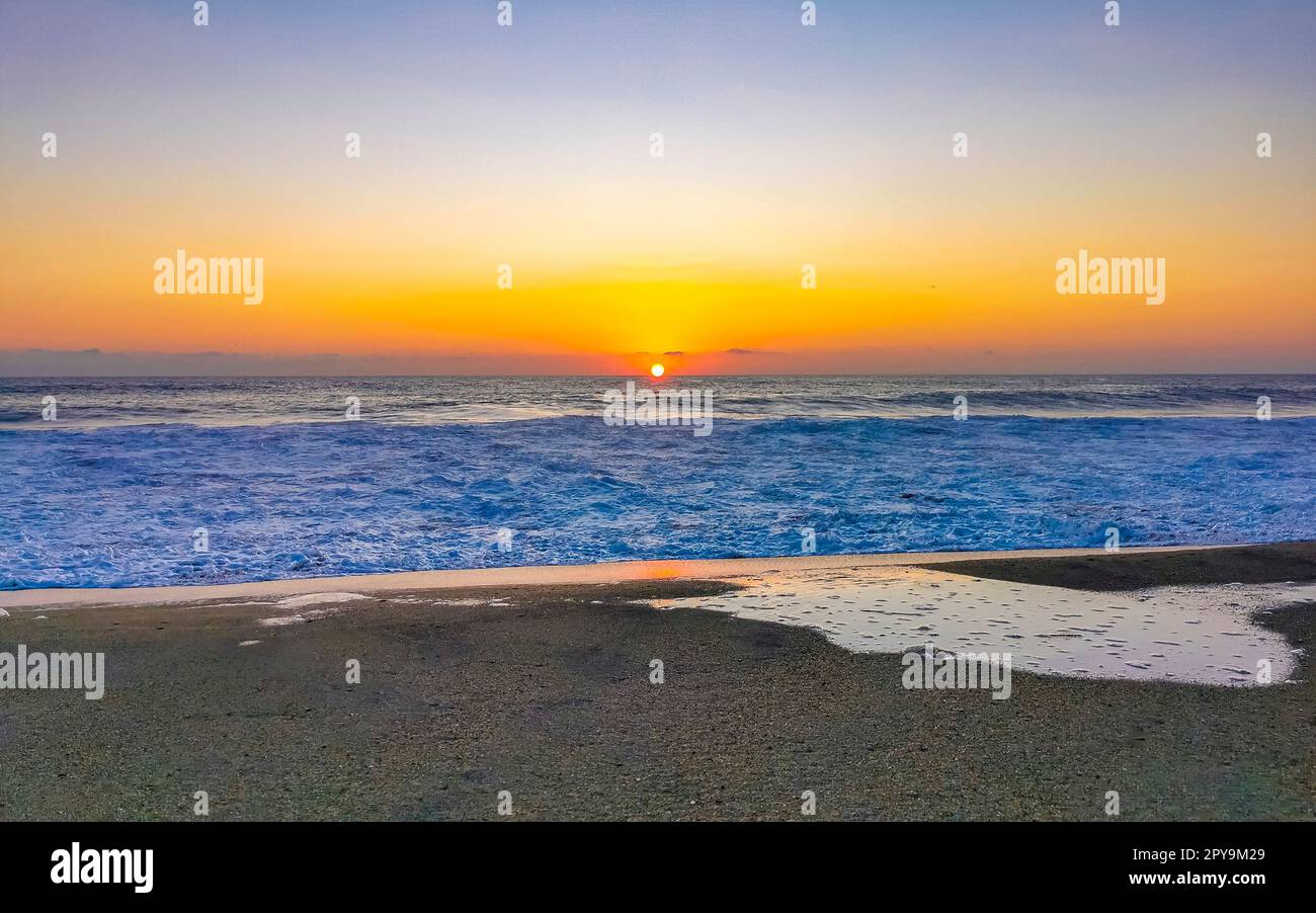 Coucher de soleil doré coloré grande vague et plage Puerto Escondido Mexique. Banque D'Images
