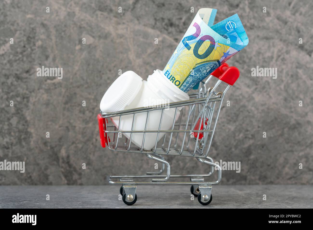 Bouteille de pilule avec vingt euros dans un panier Banque D'Images