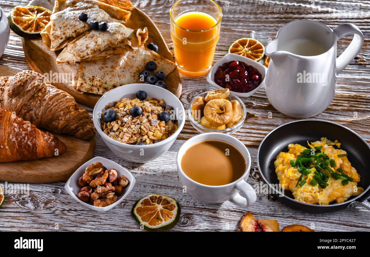 Petit déjeuner servi avec café, œufs, céréales et croissants Banque D'Images