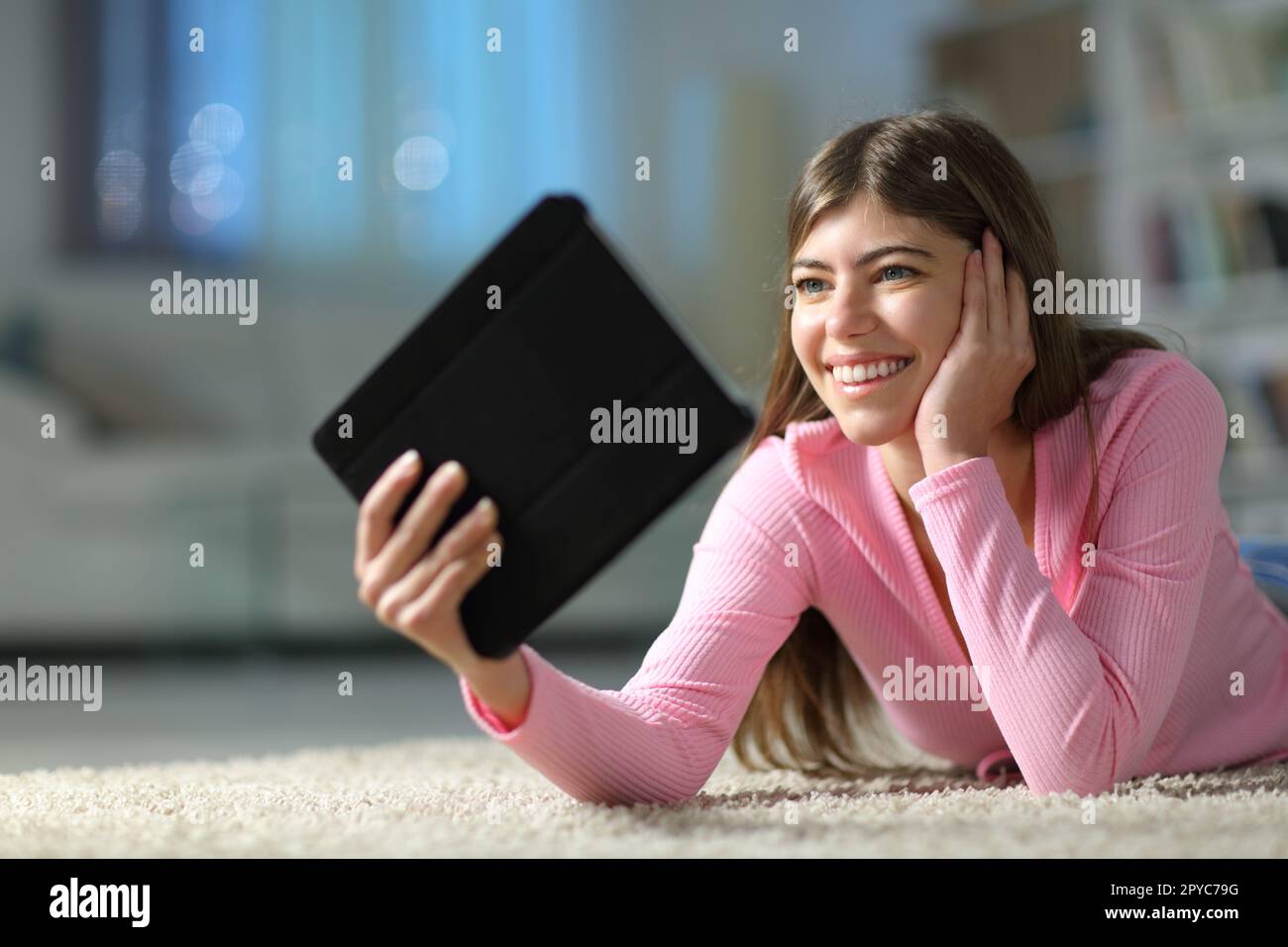 Heureux adolescent regardant les médias sur tablette à la maison Banque D'Images