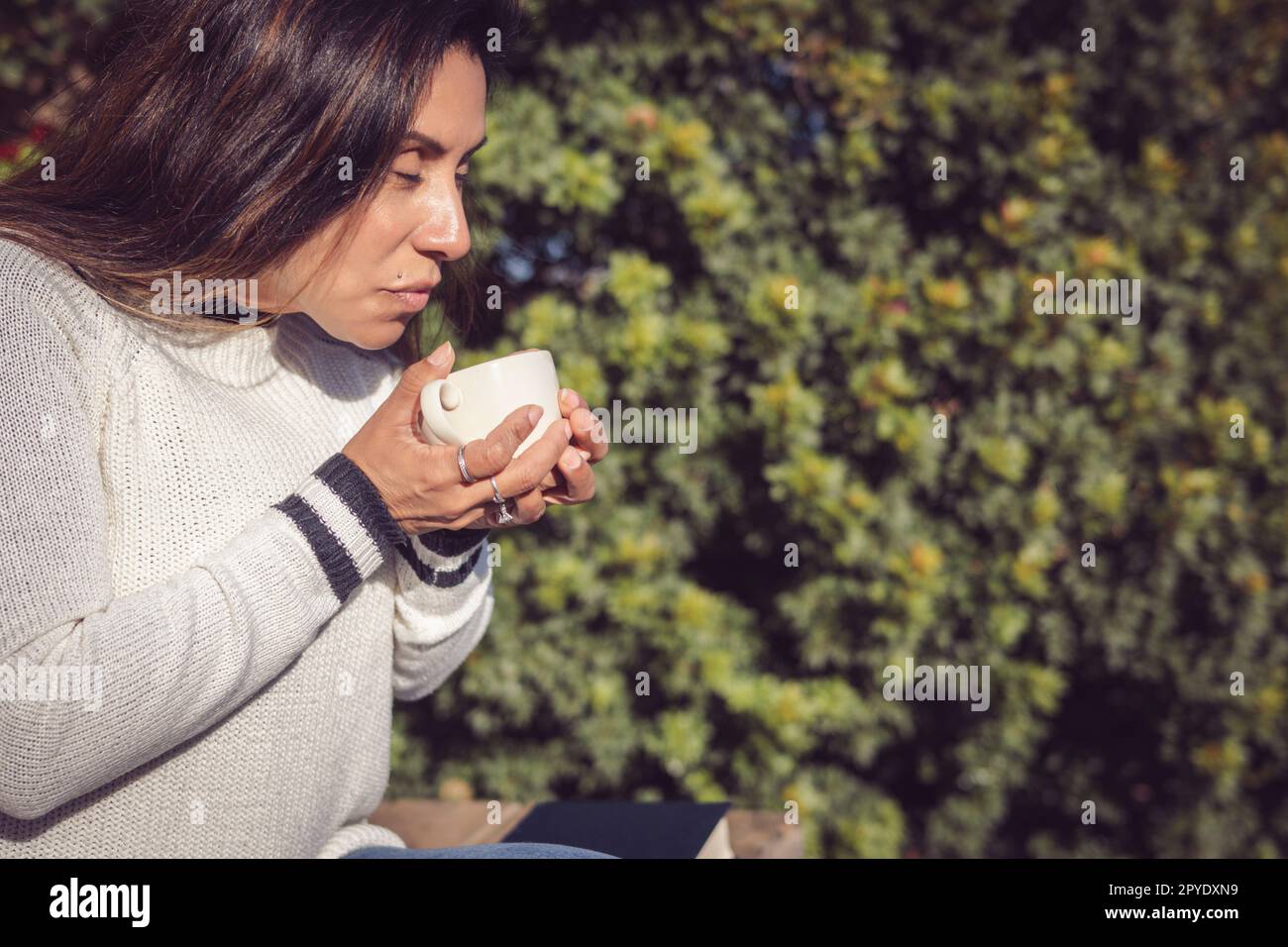 Déconnexion, Latina femme prenant une pause avec le café dans le jardin Banque D'Images