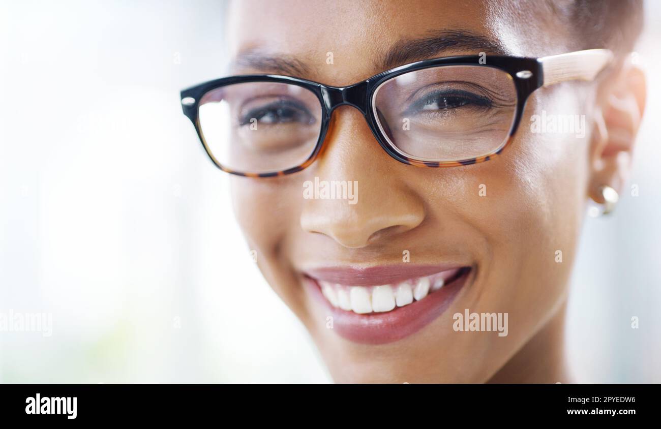 A002 C045 11280V copie. Gros plan d'une jeune femme d'affaires attirante portant des lunettes dans un bureau moderne. Banque D'Images