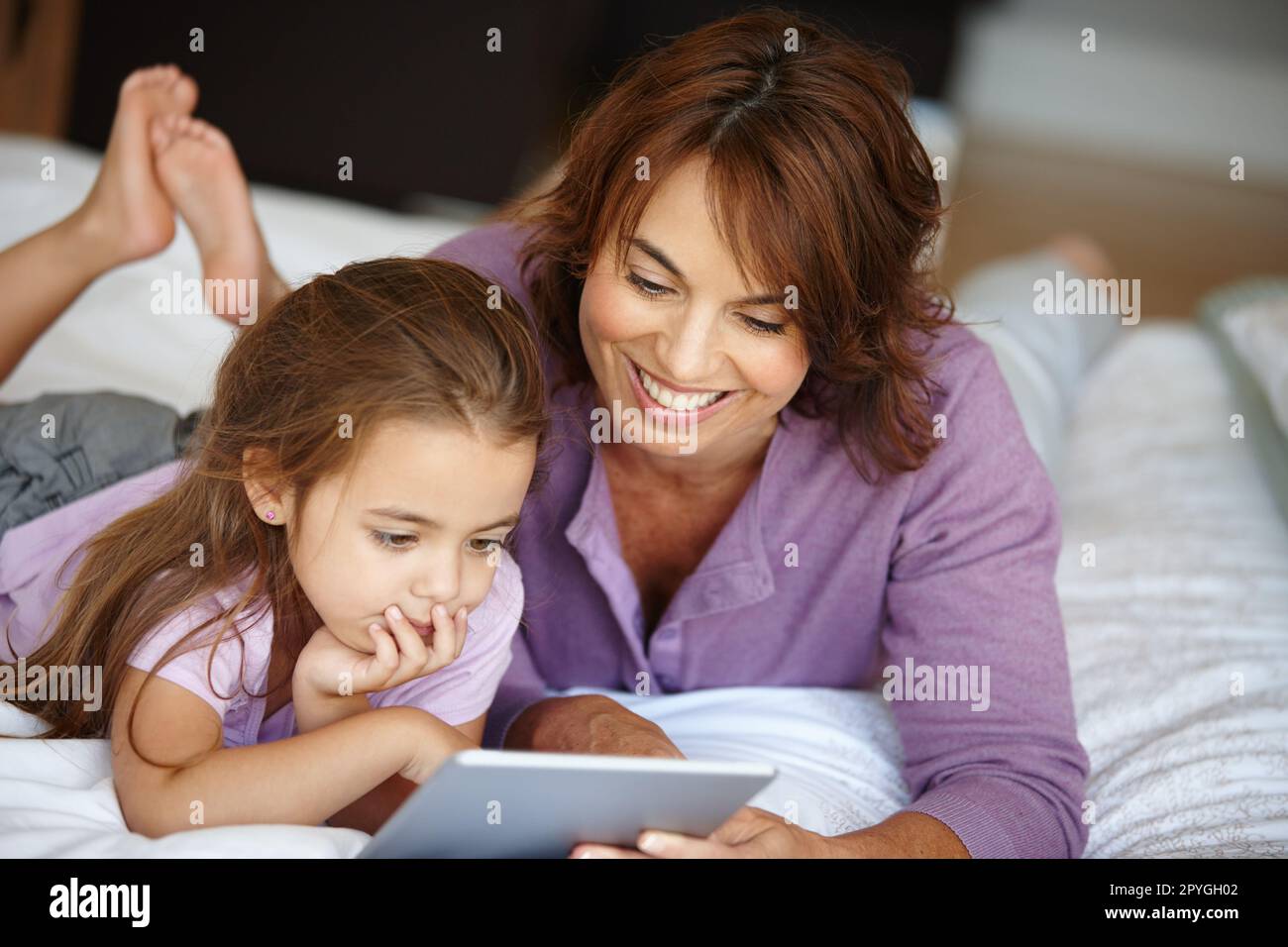 Lisons une histoire. une mère et une fille utilisant une tablette numérique  ensemble à la maison Photo Stock - Alamy