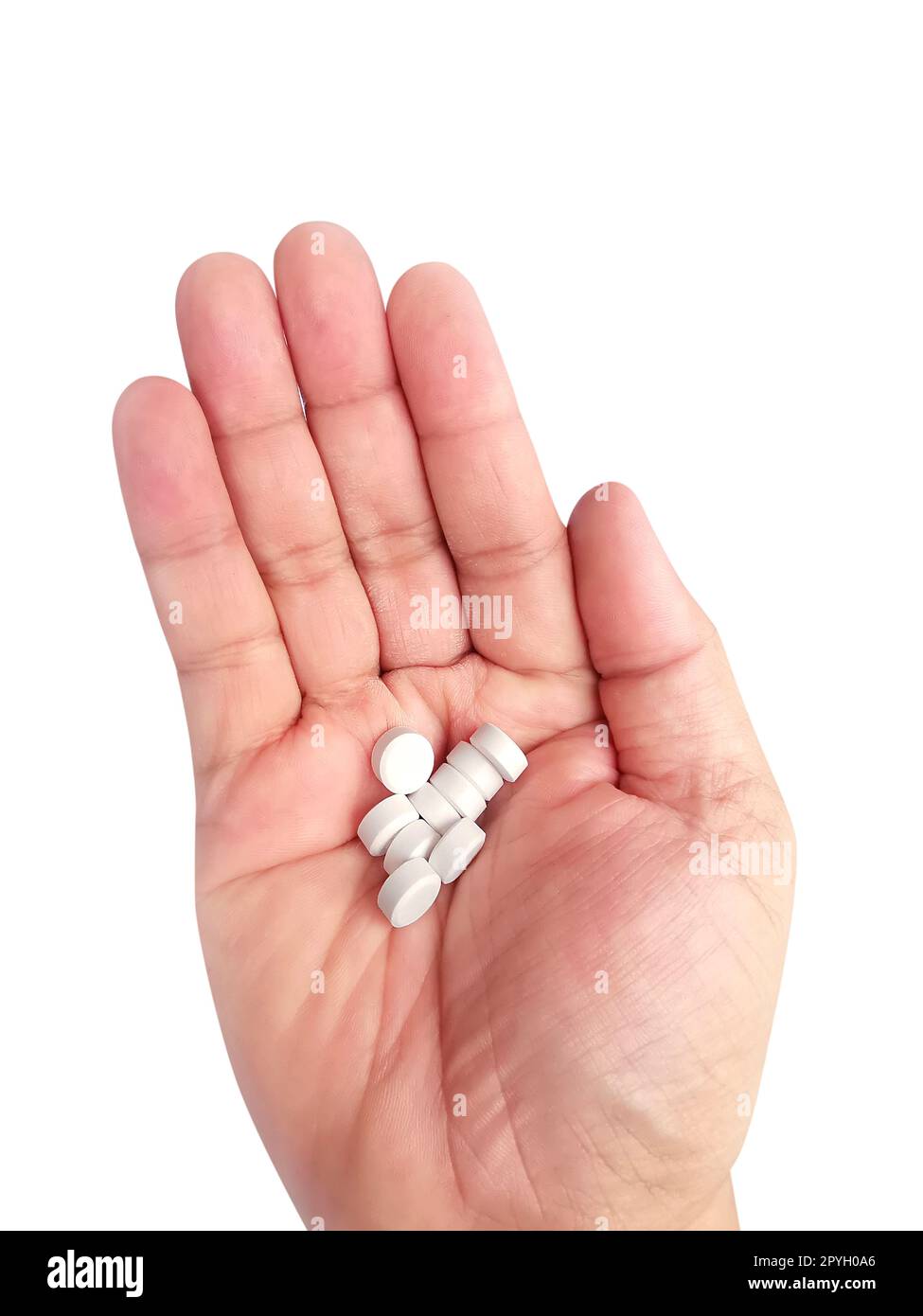 Une poignée de pilules blanches à la main sur un fond blanc Banque D'Images